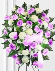 Bright pink and white standing spray featuring fresh flowers, designed for funerals and memorial services."