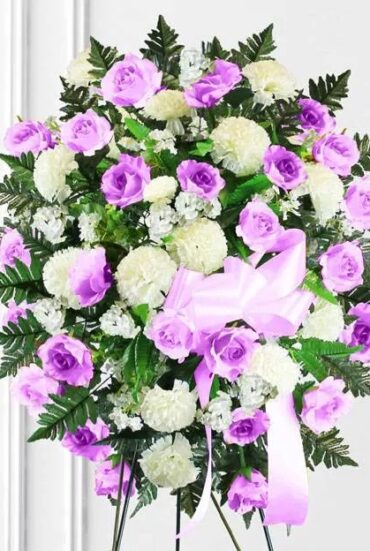 Bright pink and white standing spray featuring fresh flowers, designed for funerals and memorial services."