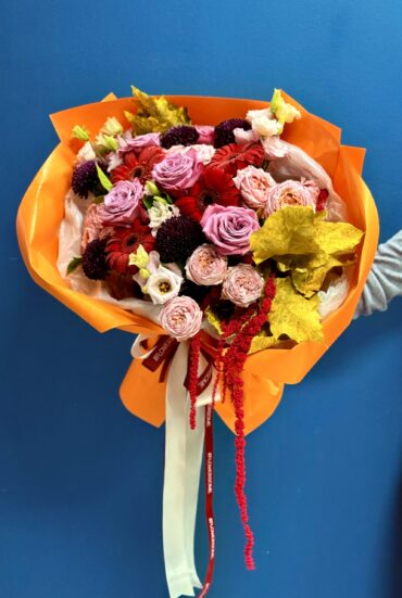 Autumn Radiance Bouquet showcasing vibrant orange, purple, and yellow flowers in a beautiful arrangement."