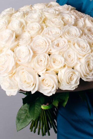 A bouquet of 50 white roses arranged in a decorative bouquet