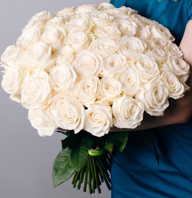 A bouquet of 50 white roses arranged in a decorative bouquet