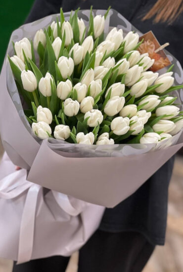 A stunning arrangement of 51 pristine white tulips, radiating elegance and natural beauty.